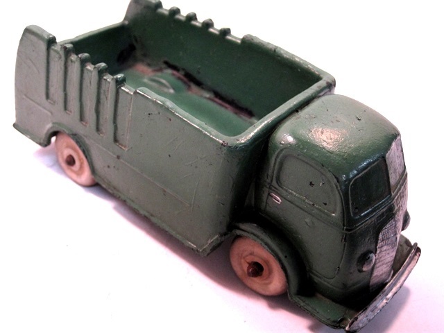Front quarter view of the large green, 1937 International cabover truck with white wheels. Square bumper.