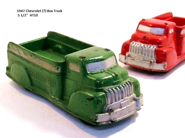 This rough and ready green truck (foreground) is likely a 1947 Chevrolet box truck. The same truck
				in red is shown just behind it.