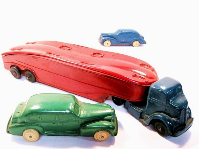 A photo of this car carrier with the two cars removed. This allows one to see the indentations in the top plate that hold the cars in place.