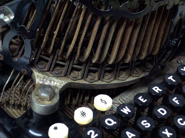 This is a close up view of the top left of the keyboard and the base of the typebar mechanism.