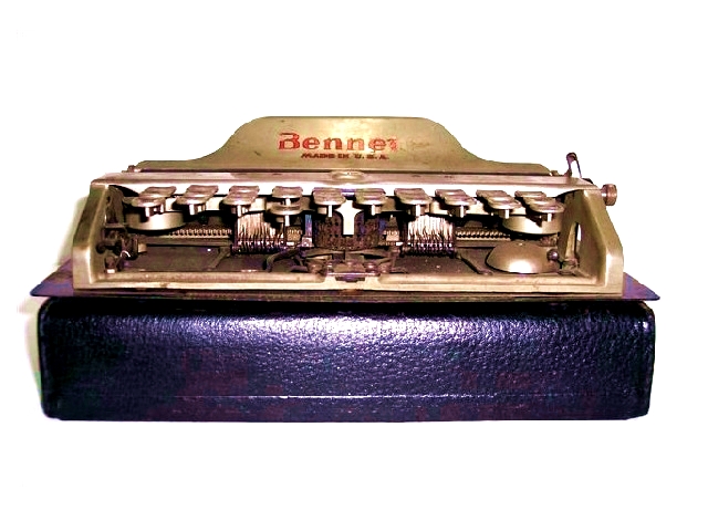 This is a front view of the typewriter sitting atop its case. One can see all the springs and mechanism that make the keyboard work.