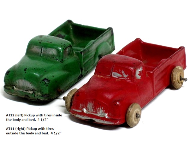 Two Aurburn pickkup trucks, one green with tires inside the truck body, 
				one red with tires outside the truck body. The trucks are both 4 1/2 inches long.