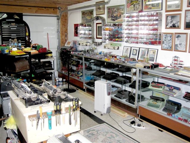 The south wall, shown below in this photo, has a display case
				containing half of the toy typewriter collection. The other half is in another case at the east end of the wall.